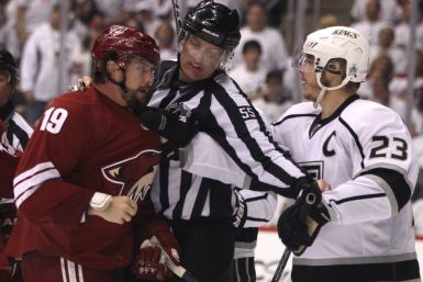 NHL linesman Heyer keeps Los Angeles Kings&#039; Brown and Phoenix Coyotes&#039; Doan apart in the 3rd period during Game 1 of the NHL Western Conference Finals.