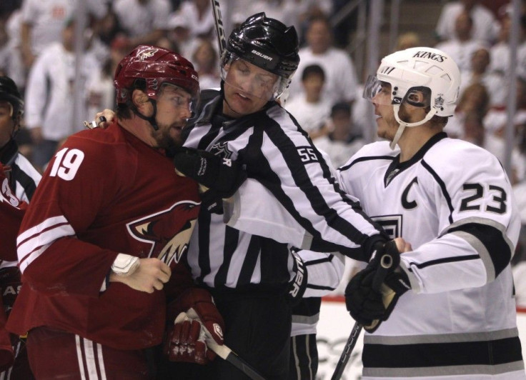 NHL linesman Heyer keeps Los Angeles Kings&#039; Brown and Phoenix Coyotes&#039; Doan apart in the 3rd period during Game 1 of the NHL Western Conference Finals.