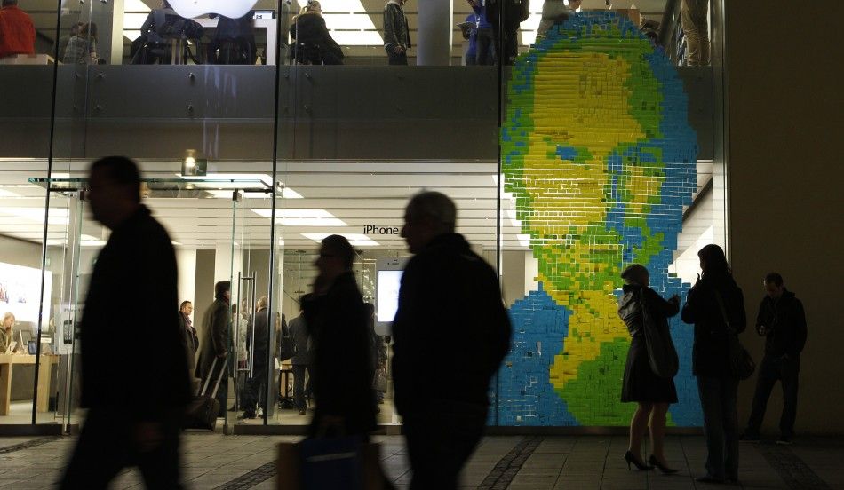 The face of Apple co-founder and former CEO Steve Jobs is created with adhesive notes on the window of an Apple Store in Munich