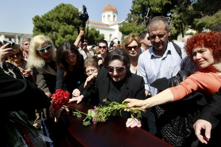 Anthoula Christoula, former wife of Dimitris Christoulas, cries over his coffin during a funeral procession in Athens