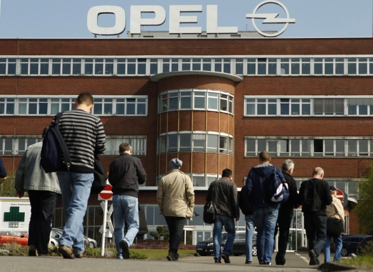 Workers arrive for their change of shift at the Opel plant of Bochum