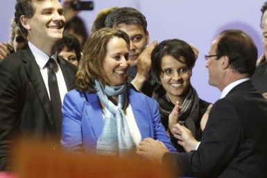(L-R) French Socialist party members Arnaud Montebourg, Segolene Royal and Najat Vallaud-Belkacem and France's newly-elected President Francois Hollande celebrate on stage with during a victory rally at Place de la Bastille in Paris early May 7, 2012.