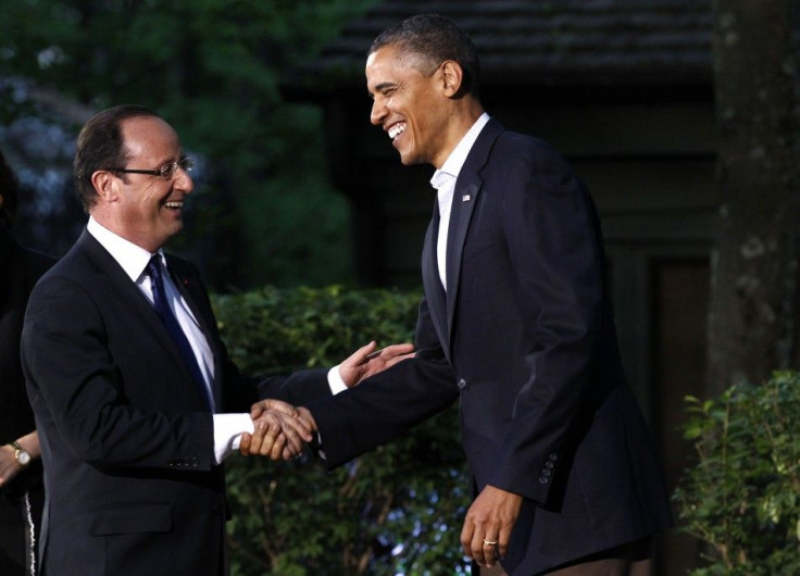 U.S. President Barack Obama greets French President Francois Hollande as he arrives at the G8 Summit at Camp David
