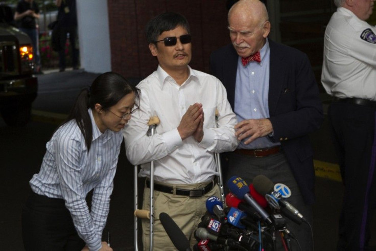  Blind Chinese dissident Chen Guangcheng (C) speaks to members of the media after arriving in New York