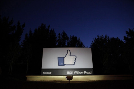 The sun rises behind the entrance sign to Facebook headquarters in Menlo Park before the company's IPO launch, May 18, 2012.