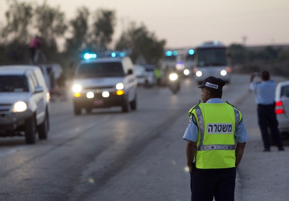 An Israeli policeman stands guard as a convoy carrying Palestinian prisoners leaves the Ketziot prison in southern Israel October 18, 2011.