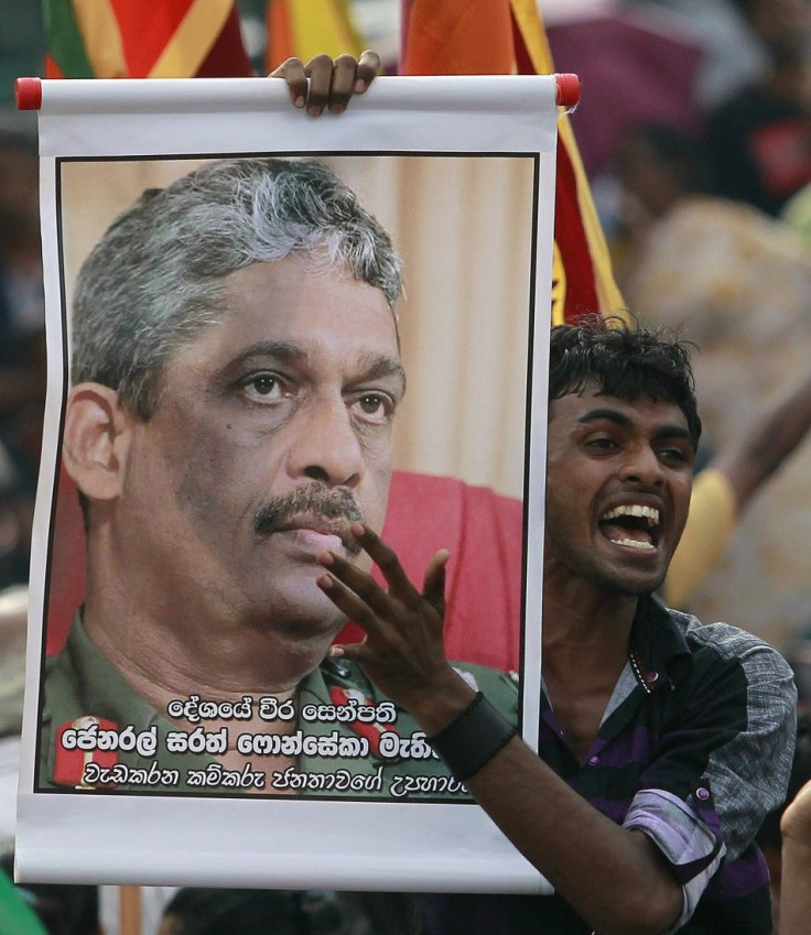 A supporter of Ex-General Sarath Fonseka holds up a banner with his image in-front of the Welikada prison as he waits for Fonseka in Colombo