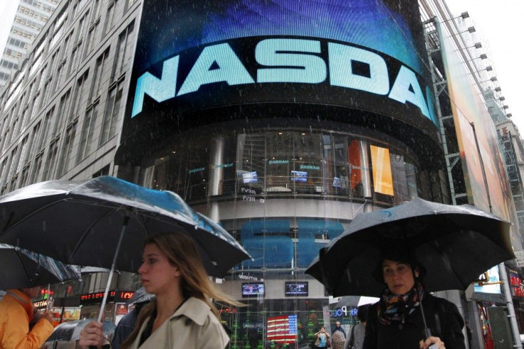 Commuters pass by Nasdaq headquarters in New York.