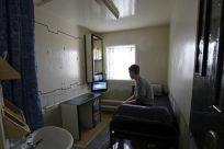 A prisoner sits in his cell on the resettlement wing in Doncaster Prison