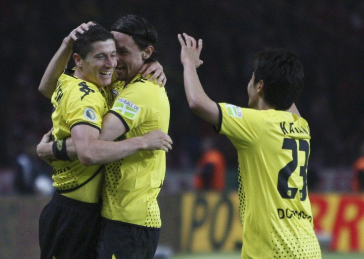 Robert Lewandowski (L), Neven Subotic and Shinji Kagawa (R)