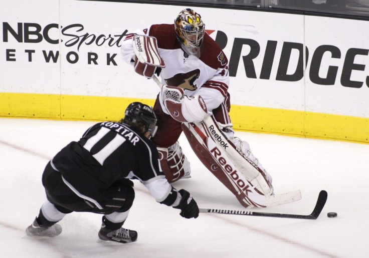 Phoenix Coyotes goalie Smith plays the puck with Los Angeles Kings' Kopitar during the second period of Game 4 of the NHL Western Conference final hockey playoffs in Los Angeles