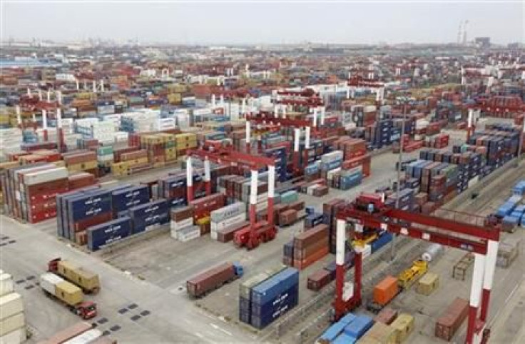 Trucks are driven into a shipping container area at Qingdao port