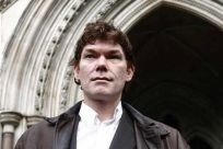 Computer expert Gary McKinnon is seen posing after arriving at the High Court, in London