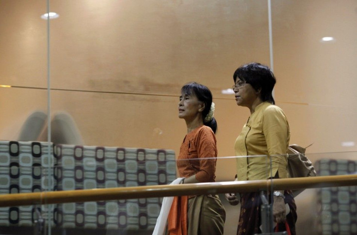 Myanmar&#039;s pro-democracy leader Suu Kyi walks towards the gate after passing immigration control at Yangon&#039;s airport