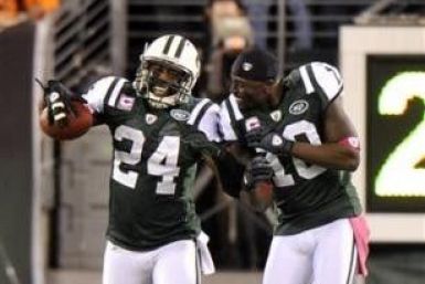 New York Jets' Darrelle Revis (L) celebrates with teammate Santonio Holmes after Revis returned an interception for a touchdown against the Miami Dolphins in the first half of their NFL game in East Rutherford, New Jersey