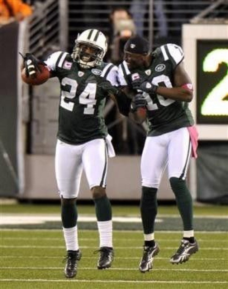 New York Jets' Darrelle Revis (L) celebrates with teammate Santonio Holmes after Revis returned an interception for a touchdown against the Miami Dolphins in the first half of their NFL game in East Rutherford, New Jersey