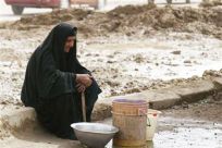 Iraqi woman waits for water