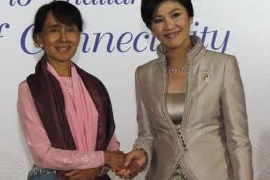 Myanmar's pro-democracy leader Suu Kyi shakes hands with Thailand's PM Yingluck before a gala dinner as part of the World Economic Forum on East Asia in Bangkok