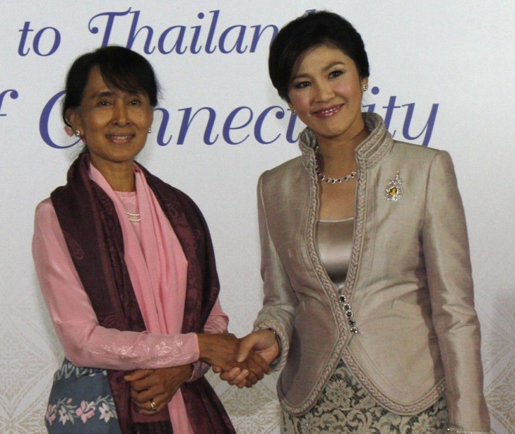 Myanmar's pro-democracy leader Suu Kyi shakes hands with Thailand's PM Yingluck before a gala dinner as part of the World Economic Forum on East Asia in Bangkok