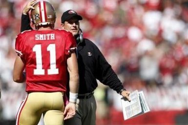 San Francisco 49ers head coach Jim Harbaugh (R) congratulates quarterback Alex Smith after a touchdown during the second quarter of their NFL football game against the Tampa Bay Buccaneers in San Francisco, California