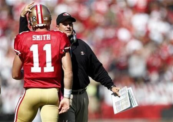 San Francisco 49ers head coach Jim Harbaugh (R) congratulates quarterback Alex Smith after a touchdown during the second quarter of their NFL football game against the Tampa Bay Buccaneers in San Francisco, California