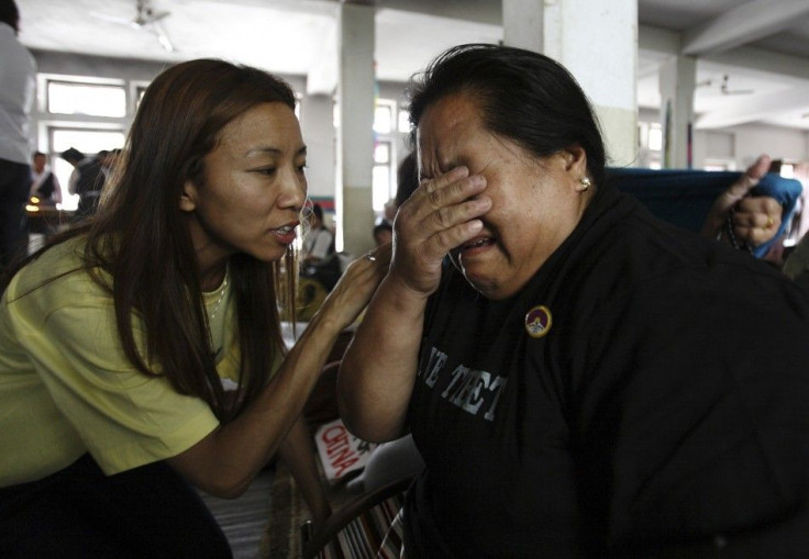 A Tibetan woman living in Nepal is comforted by a friend as she cries during a hunger strike in Kathmandu