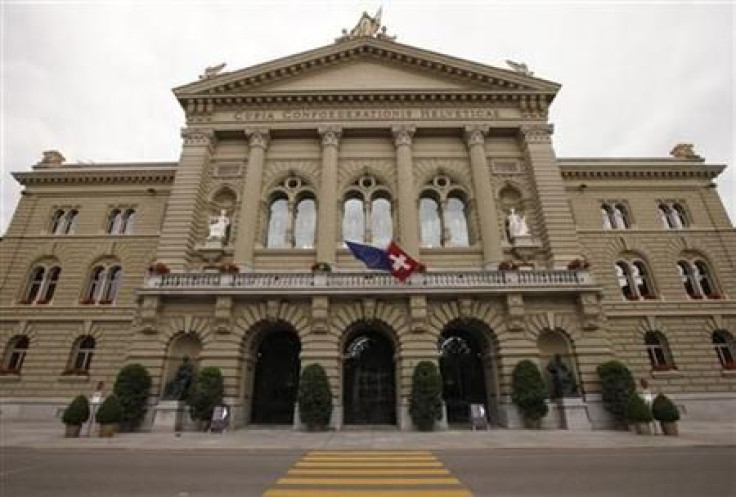 The flags of the European Union and Switzerland flutter in the wind at the Swiss parliament building in Bern