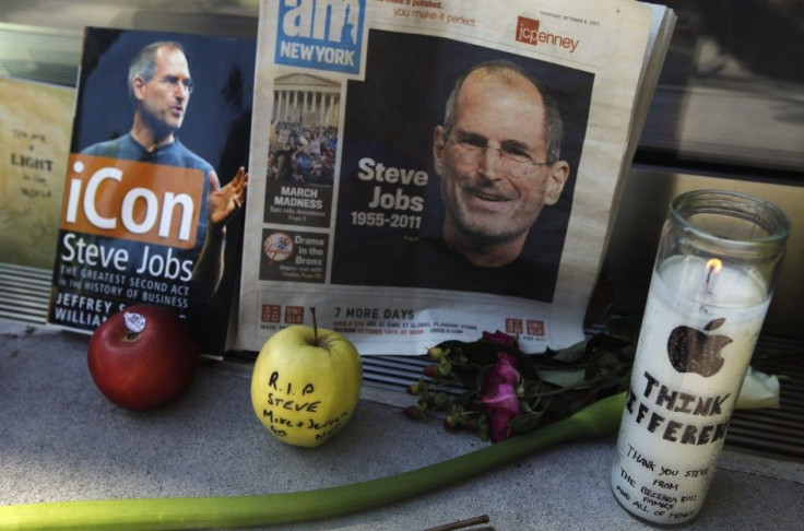 Items left at an impromptu shrine memorializing Steve Jobs are seen outside of Apple's upper west side store in New York