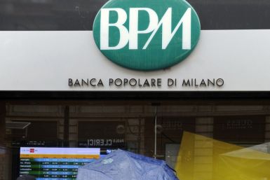 People stand in front of Banca Popolare in Milan