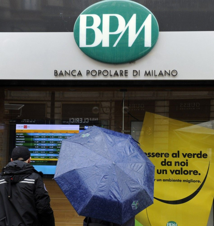 People stand in front of Banca Popolare in Milan