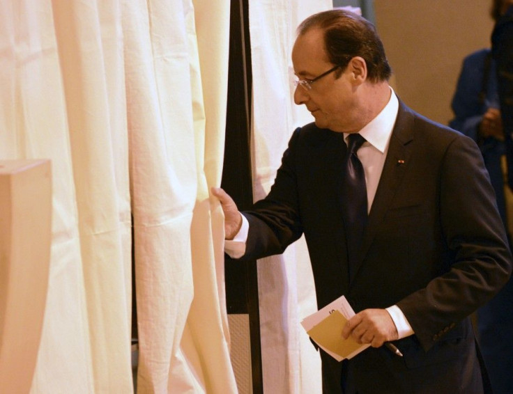 France's President Hollande enters the voting both in the legislative elections at the polling station in Tulle