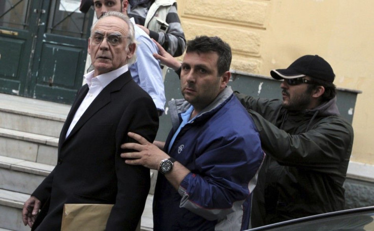 Former socialist minister Akis Tsohatzopoulos ,72, is escorted by plainclothes policemen as he is led to jail in Athens