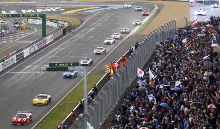 Competitors drive their cars at the start of the Le Mans 24-hour sportscar race in Le Mans