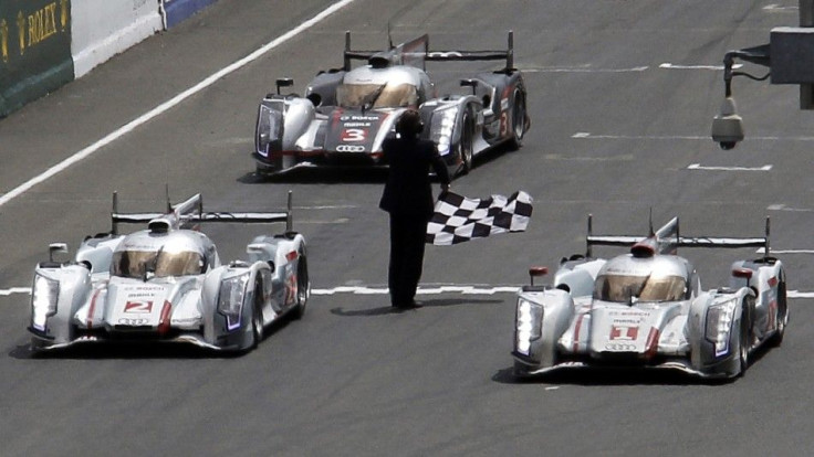 Andre Lotterer of Germany driving the Audi R18 E-Tron Quattro Number 1 crosses the finish line at the Le Mans 24-hour sportscar race in Le Mans