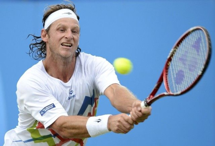 David Nalbandian of Argentina hits a return to Grigor Dimitrov of Bulgaria during their men&#039;s singles tennis match at the Queen&#039;s Club tournament in London