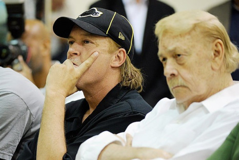 Jim Buss, left, seated next to his father Lakers owner Jerry Buss at a game.
