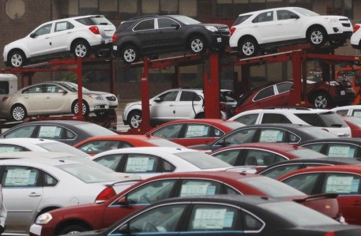 Newly built cars sit in a shipping lot near General Motors Car assembly plant in Oshawa