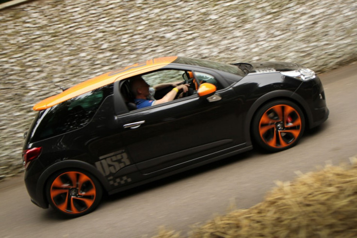 A Mini drives during the Goodwood Festival of Speed 2012 Moving Motor Show, Thursday.