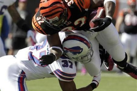 Cincinnati Bengals&#039; running back Cedric Benson (32) is tackled by Buffalo Bills&#039; George Wilson (37) during the first half of play in their NFL football game at Paul Brown Stadium in Cincinnati, Ohio