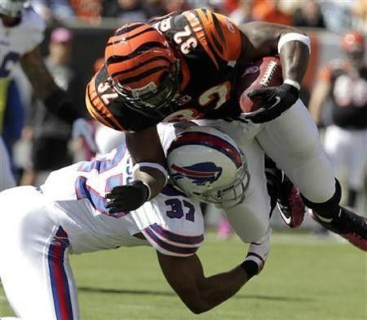 Cincinnati Bengals&#039; running back Cedric Benson (32) is tackled by Buffalo Bills&#039; George Wilson (37) during the first half of play in their NFL football game at Paul Brown Stadium in Cincinnati, Ohio