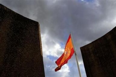 A Spanish flag flutters over the Colon square in central Madrid