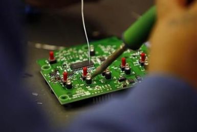 A worker solders a circuit board at the manufacturing facility of VAS, an Electronics manufacturer in San Diego