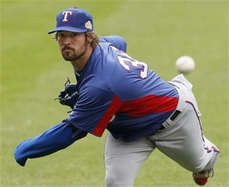 Texas Rangers starting pitcher C.J. Wilson warms-up during practice in St. Louis, Missouri