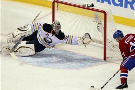 Buffalo Sabres goalie Ryan Miller (30) makes a save on a shot by Montreal Canadiens Tomas Plekanec (14) during second period NHL hockey action in Montreal, October 18, 2011.
