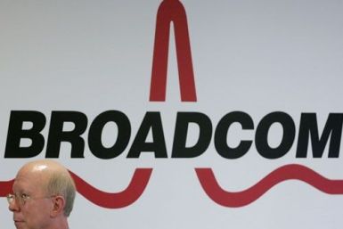 Broadcom CEO Scott McGregor stands in front of the company's logo in Taipei
