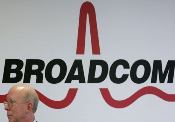 Broadcom CEO Scott McGregor stands in front of the company's logo in Taipei