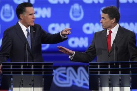GOP presidential candidates former Massachusetts Governor Mitt Romney (L) and Texas Governor Rick Perry debate illegal immigration as they take part in the CNN Western Republican debate in Las Vegas, Nevada