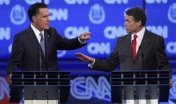 GOP presidential candidates former Massachusetts Governor Mitt Romney (L) and Texas Governor Rick Perry debate illegal immigration as they take part in the CNN Western Republican debate in Las Vegas, Nevada