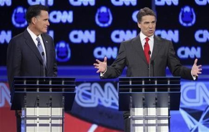 Texas Governor Rick Perry (R) speaks as former Massachusetts Governor Mitt Romney listens as they take part in the CNN Western Republican debate in Las Vegas, Nevada