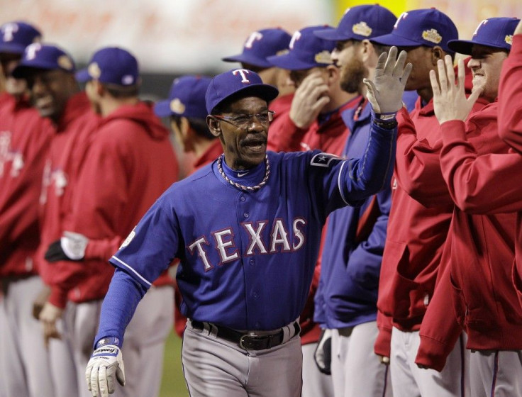Texas Rangers manager Ron Washington slaps hands with his team before the start of Game 1 of MLB&#039;s World Series baseball championship against the St. Louis Cardinals in St. Louis
